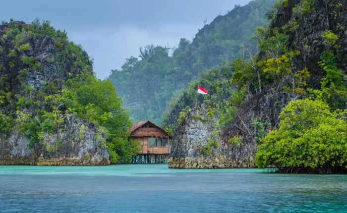 Bamboo Hut between some Rocks under Rain in Raja Ampat, Indonesia
