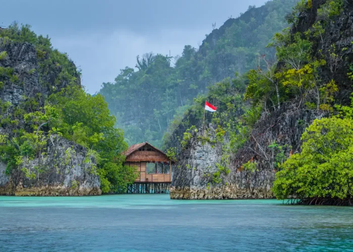 Bamboo Hut between some Rocks under Rain in Raja Ampat, Indonesia