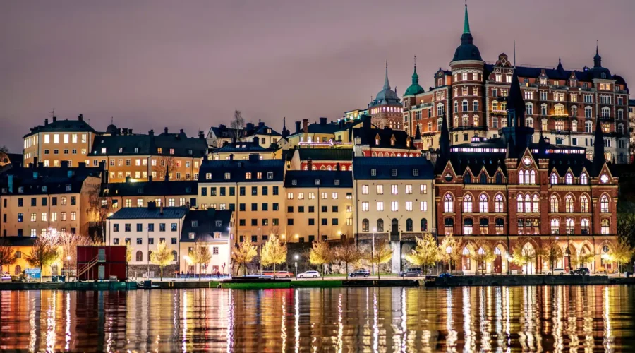Buildings line the shore of a tranquil body of water, Stockholm, Sweden Buildings line the shore of a tranquil body of water, Stockholm, Sweden